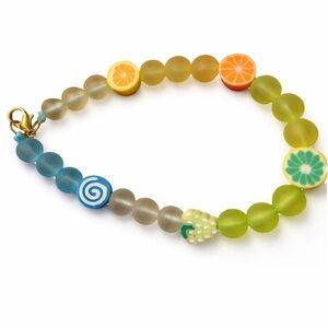 Unique plastic beaded bracelet with citrus fruit‎ design, featuring green
